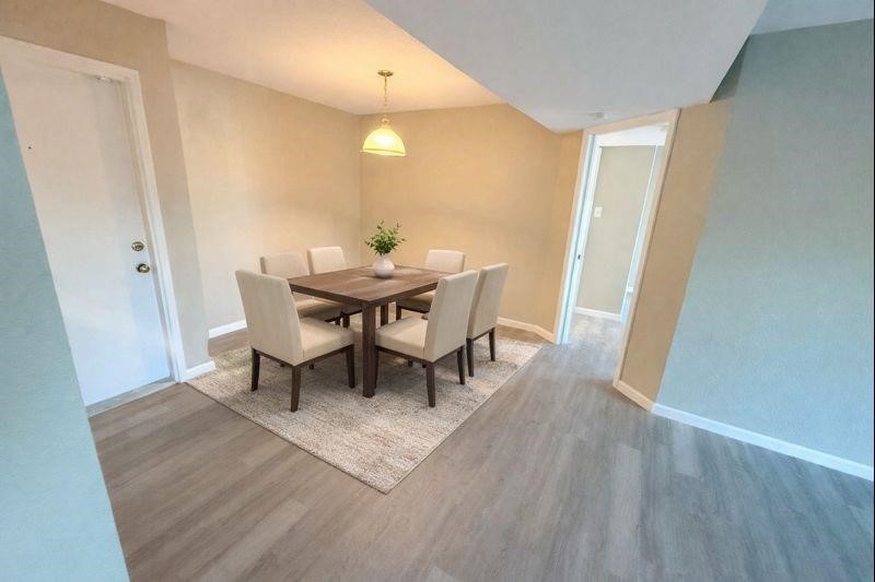 3085 Walnut Bend Lane, Unit 16 Houston, TX 77042 - Photo 2 of 13 a view of a dining room with furniture and wooden floor