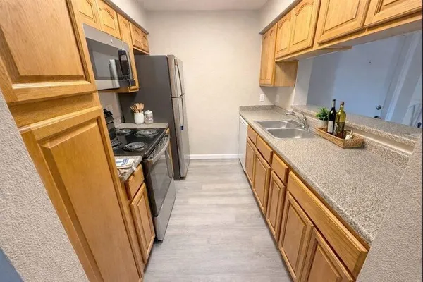 a kitchen with sink and refrigerator