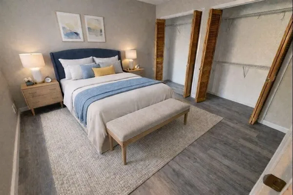 a bedroom with a bed and a mirror