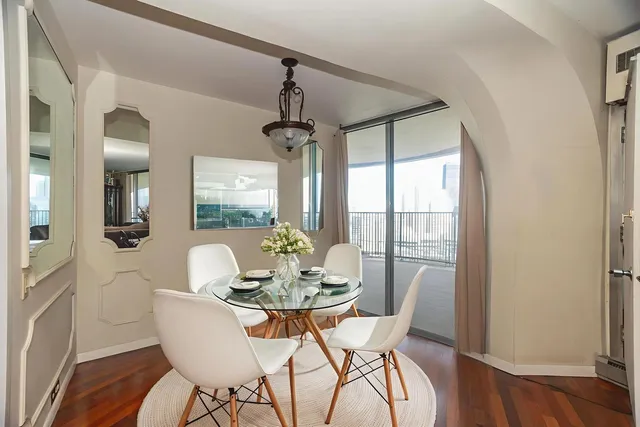 a dining room with furniture window and wooden floor