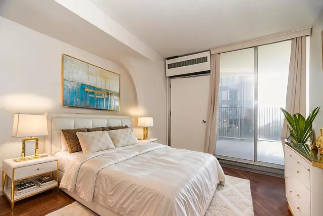 a bedroom with a bed and a potted plant