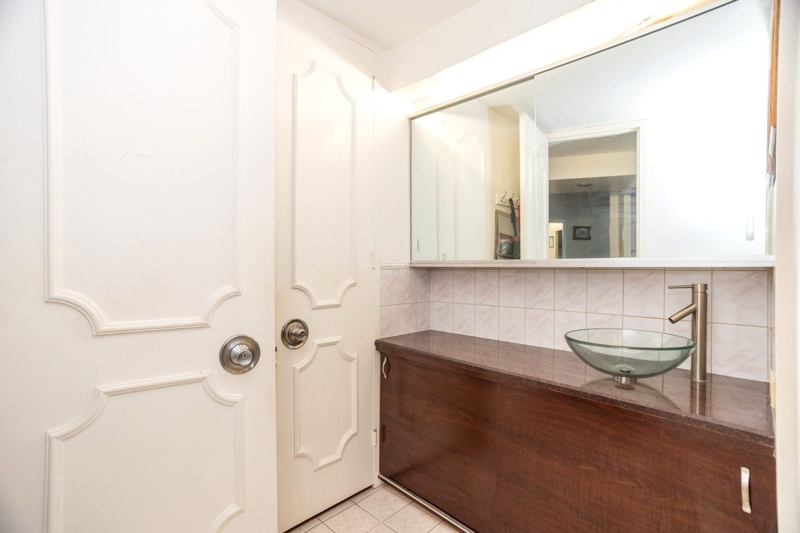 300 North State Street, Unit 5620 Chicago, IL 60654 - Photo 7 of 12 a bathroom with a sink and a mirror