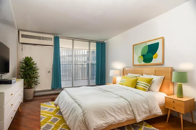 a bedroom with a bed and a window