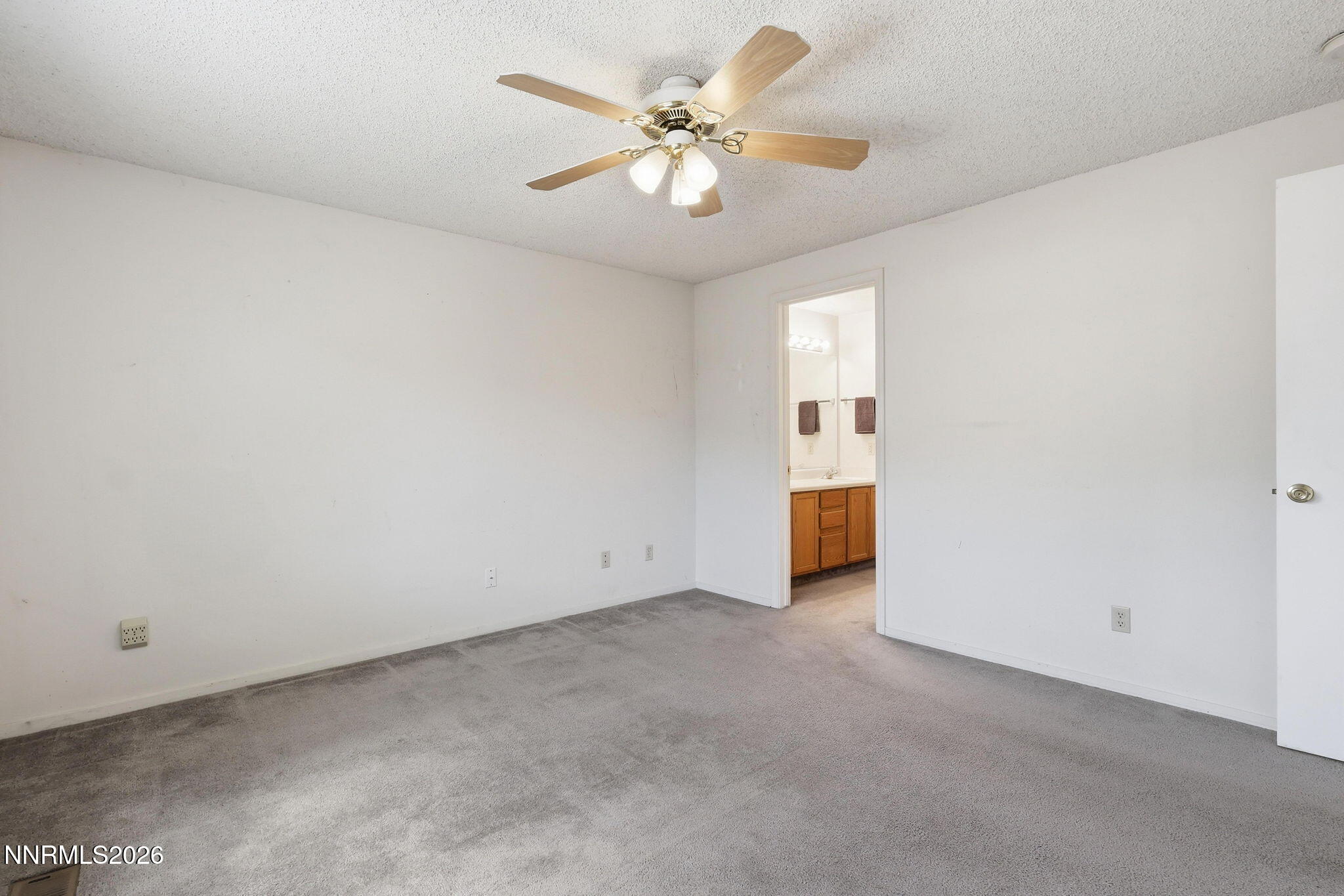 6840 Viscaya Court Reno, NV 89523 - Photo 19 of 25 an empty room with a chandelier fan and windows
