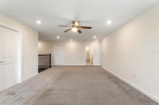 a view of a livingroom with a ceiling fan and window