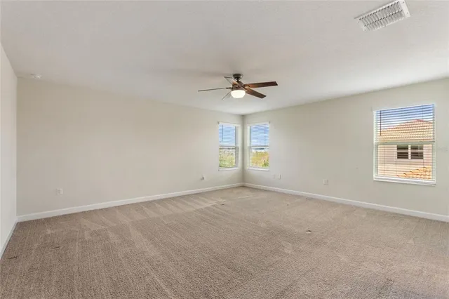 a bathroom with a bathtub a shower and a window