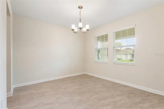 a kitchen with stainless steel appliances granite countertop a refrigerator a stove and a sink