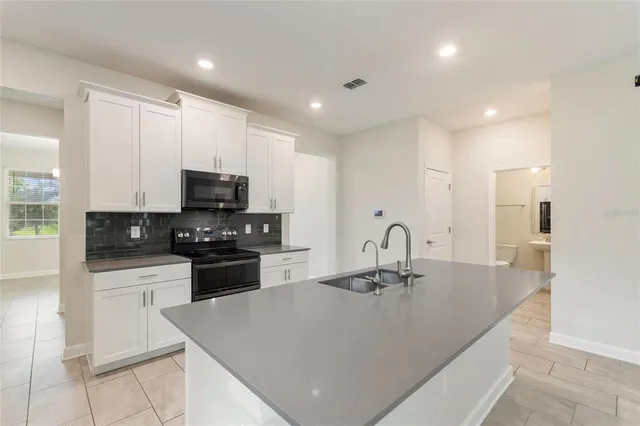 a kitchen with a sink stove and refrigerator