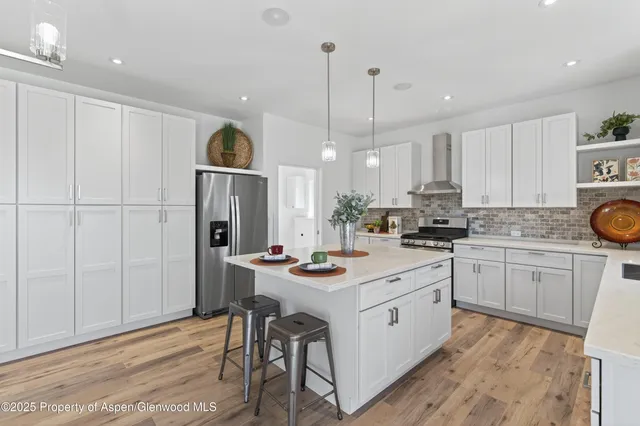 a kitchen with a sink stove and white cabinets