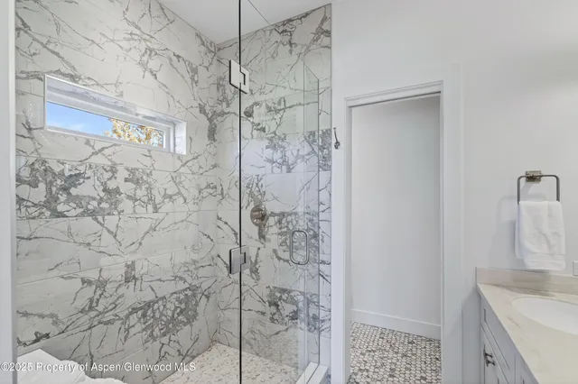 a bathroom with a shower and vanity