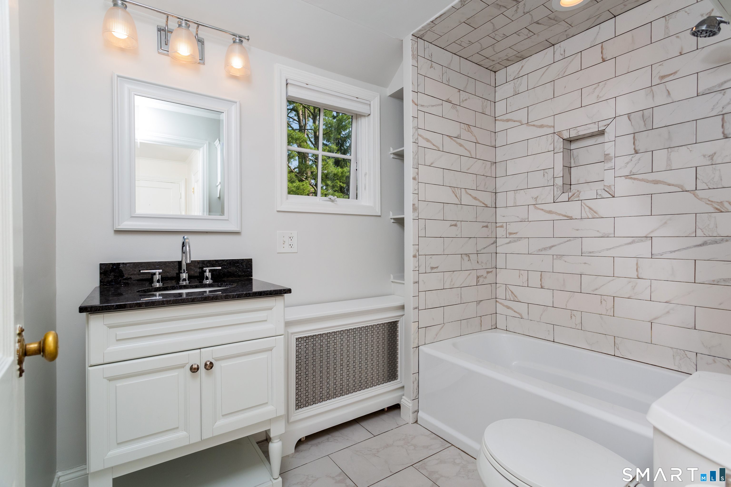 437 Hulls Farm Road Fairfield, CT 06890 - Photo 12 of 15 a bathroom with a sink a toilet and bathtub