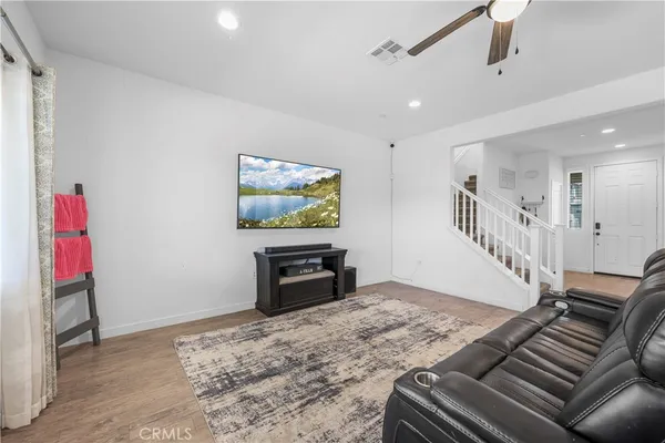 a bedroom with furniture and a flat screen tv