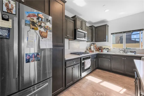 a kitchen with stainless steel appliances granite countertop a refrigerator and a sink