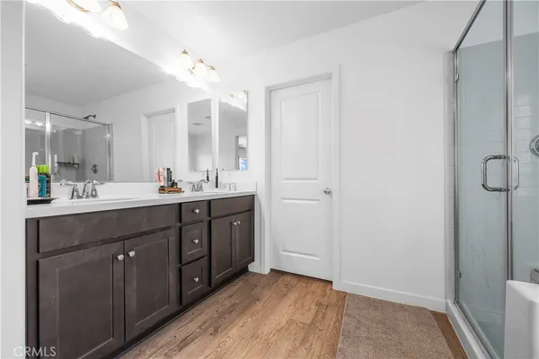 a spacious bathroom with a double vanity sink and mirror