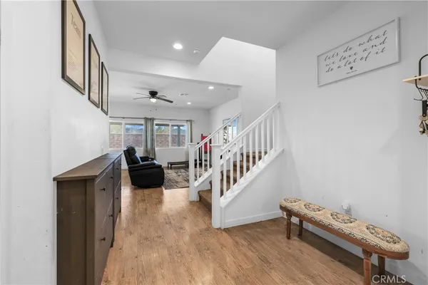 a living room with furniture and a wooden floor