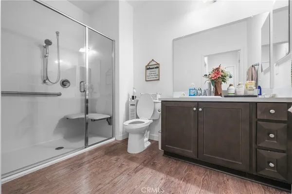 a bathroom with a sink mirror and a toilet