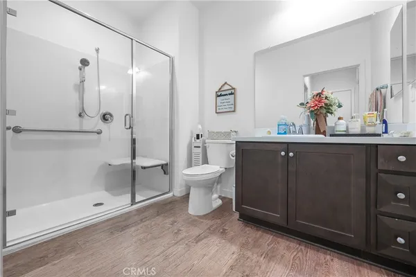a spacious bathroom with a double vanity sink toilet and shower