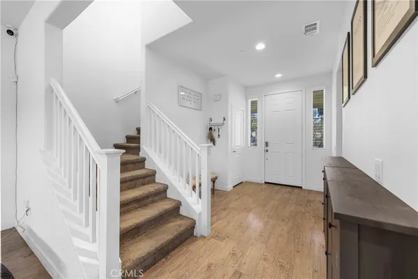 a view of entryway and hall with wooden floor