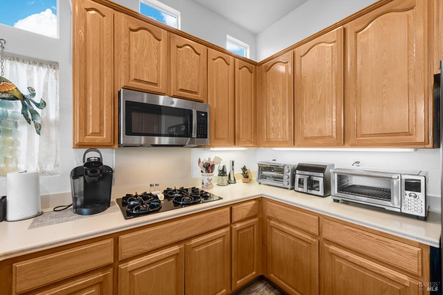 2121 St Andrews Drive Rio Vista, CA 94571 - Photo 12 of 53 a kitchen with stainless steel appliances granite countertop white cabinets a stove top oven a sink and dishwasher