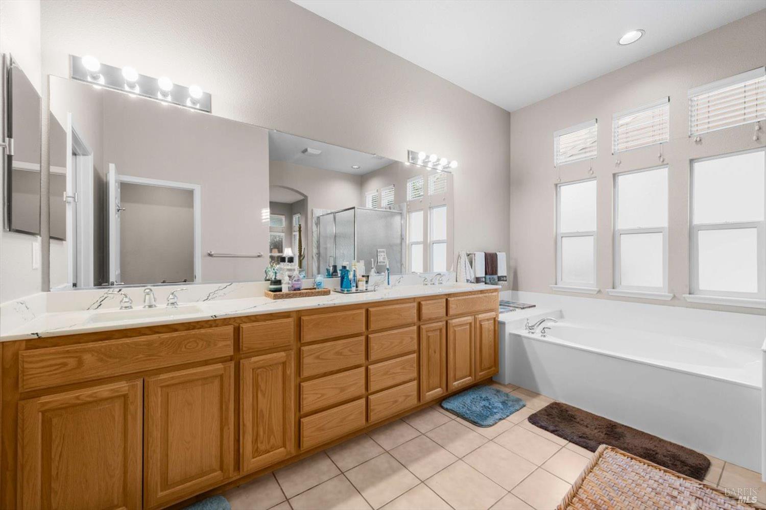 2121 St Andrews Drive Rio Vista, CA 94571 - Photo 24 of 53 a spacious bathroom with a double vanity sink a large mirror and a bathtub