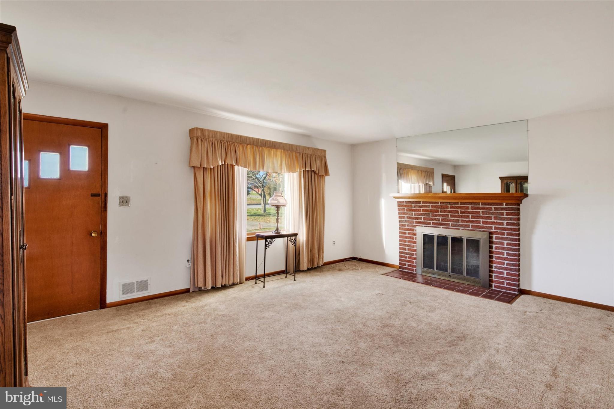 1505 Southview Road Bel Air, MD 21015 - Photo 5 of 25 an empty room with fireplace and windows