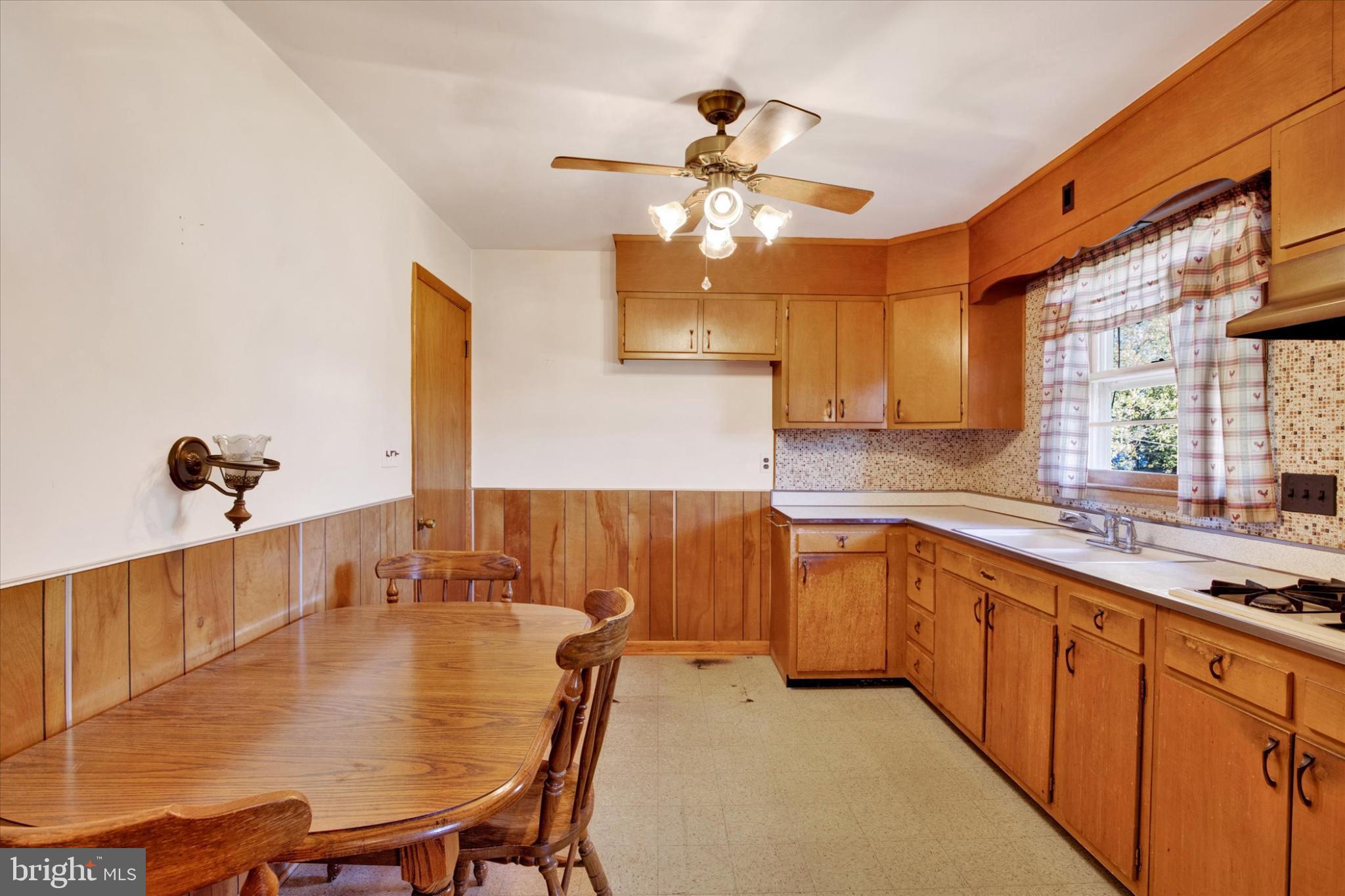 1505 Southview Road Bel Air, MD 21015 - Photo 7 of 25 a kitchen with a table chairs sink and cabinets