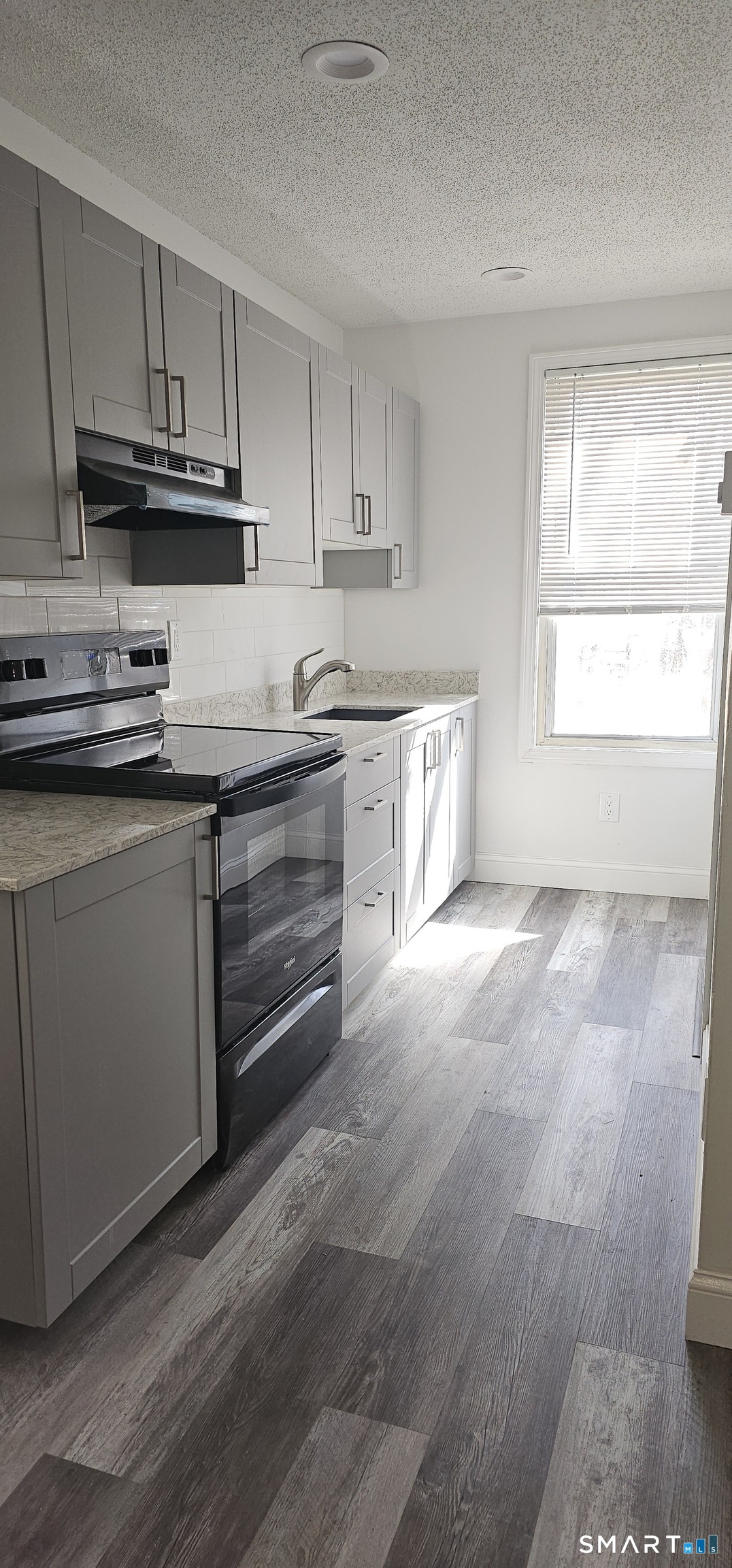 315 Grove Street Meriden, CT 06451 - Photo 3 of 11 a kitchen with granite countertop a sink cabinets and stainless steel appliances