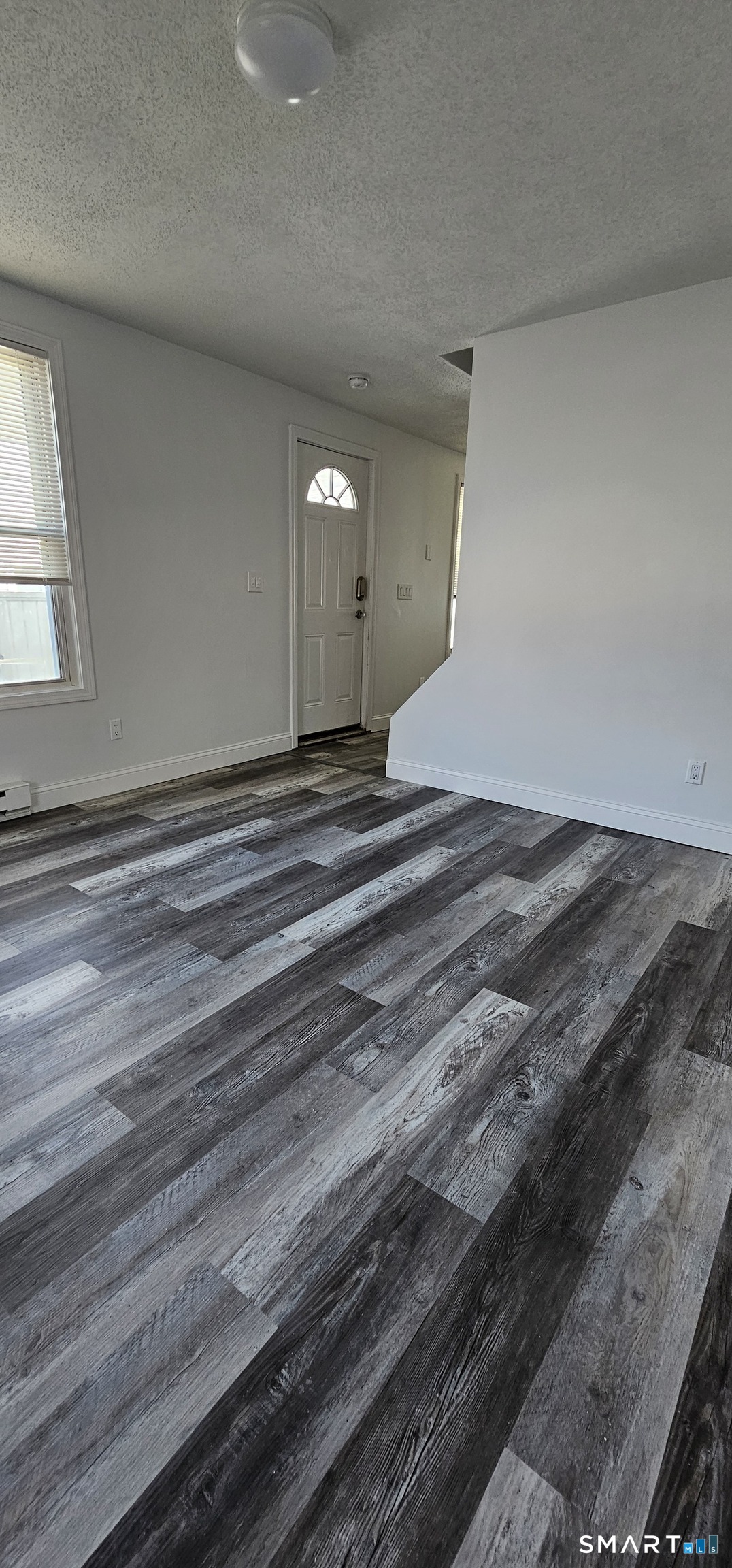 315 Grove Street Meriden, CT 06451 - Photo 4 of 11 a view of empty room with window and wooden floor