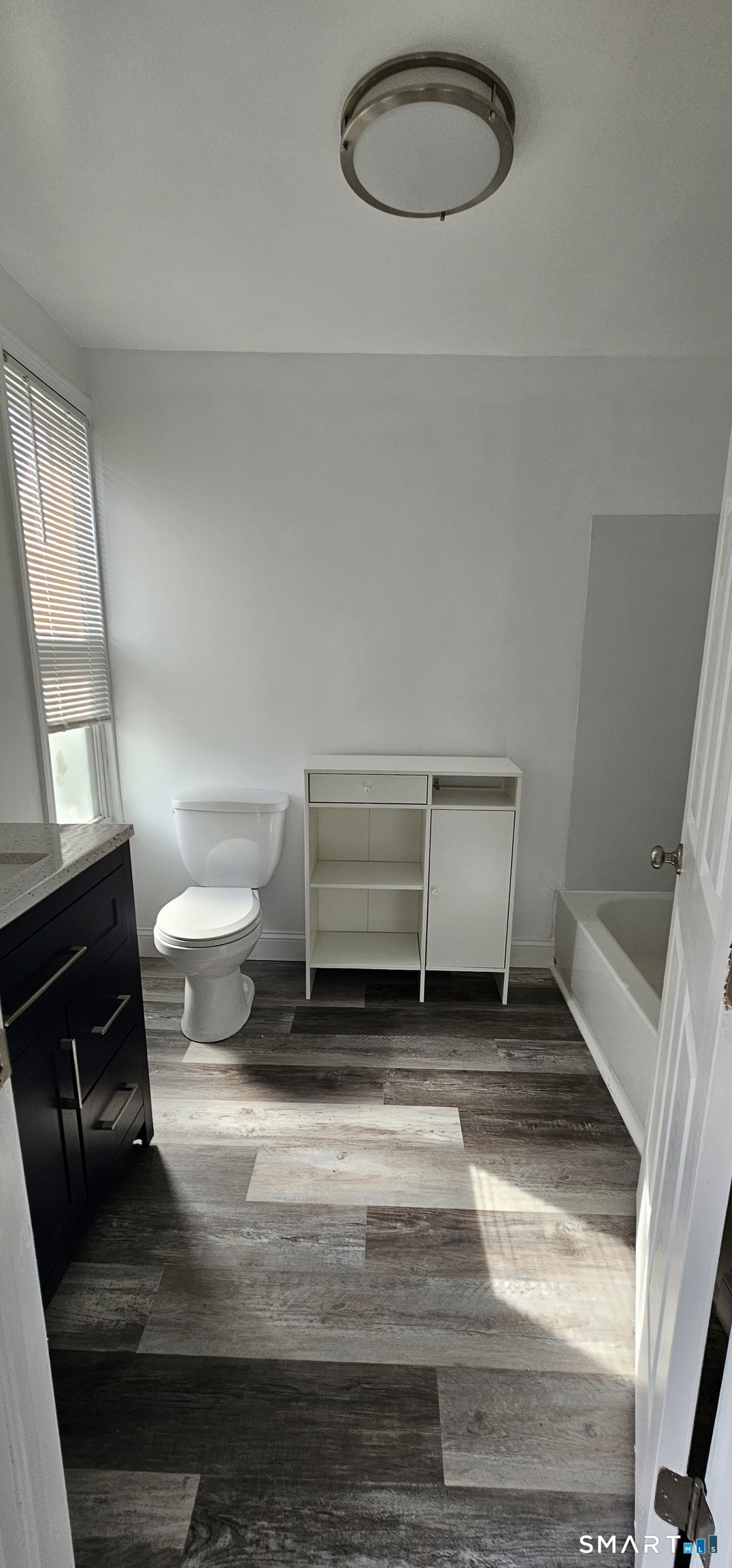 315 Grove Street Meriden, CT 06451 - Photo 9 of 11 a bathroom with a sink a toilet and a mirror
