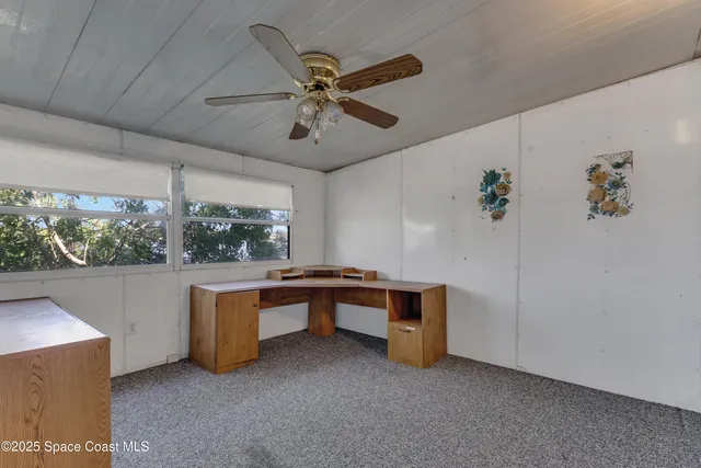 a view of workspace with furniture and a window