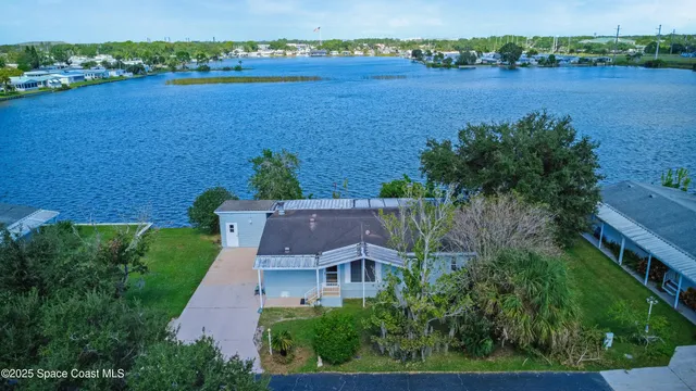 an aerial view of a house with a lake view