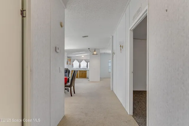 a view of a hallway with furniture