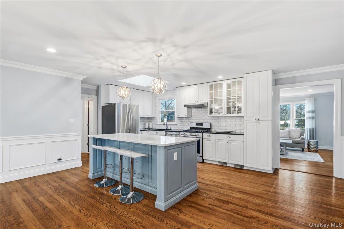 39 Darling Avenue New Rochelle, NY 10804 - Photo 4 of 19 a large kitchen with cabinets wooden floor and stainless steel appliances