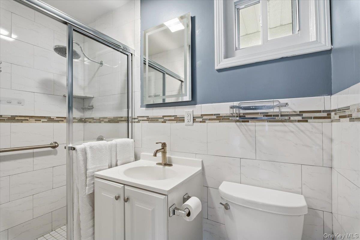 39 Darling Avenue New Rochelle, NY 10804 - Photo 10 of 19 a bathroom with a sink a toilet and a mirror