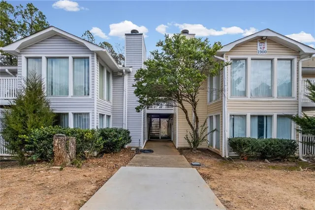 a view of a balcony with wooden floor and iron stairs