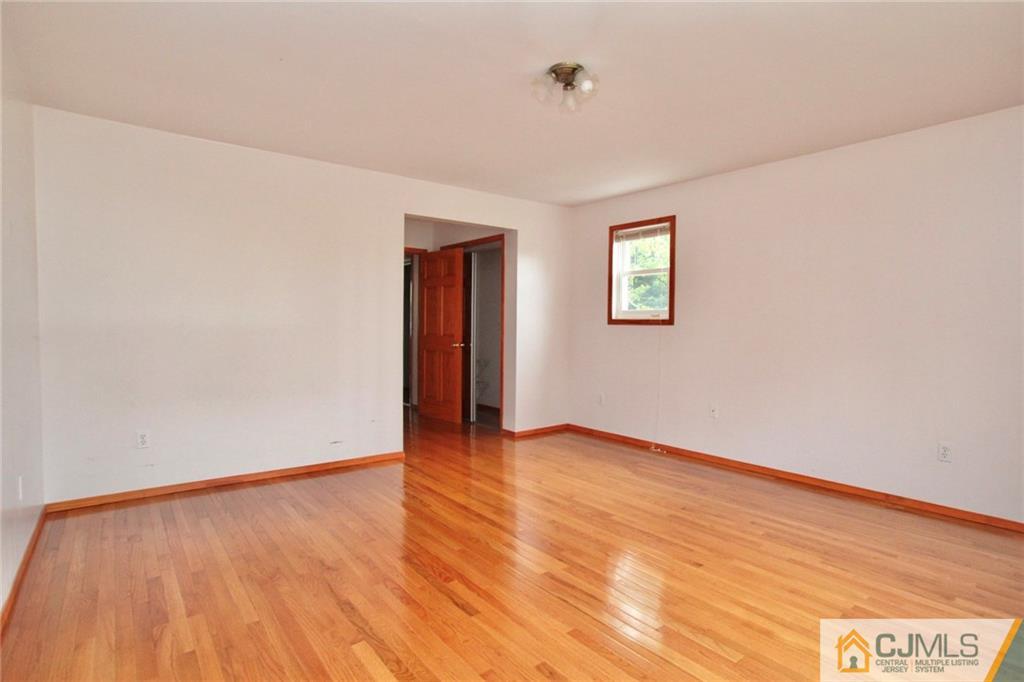 16 Ashley Road Edison, NJ 08817 - Photo 14 of 25 an empty room with wooden floor and windows