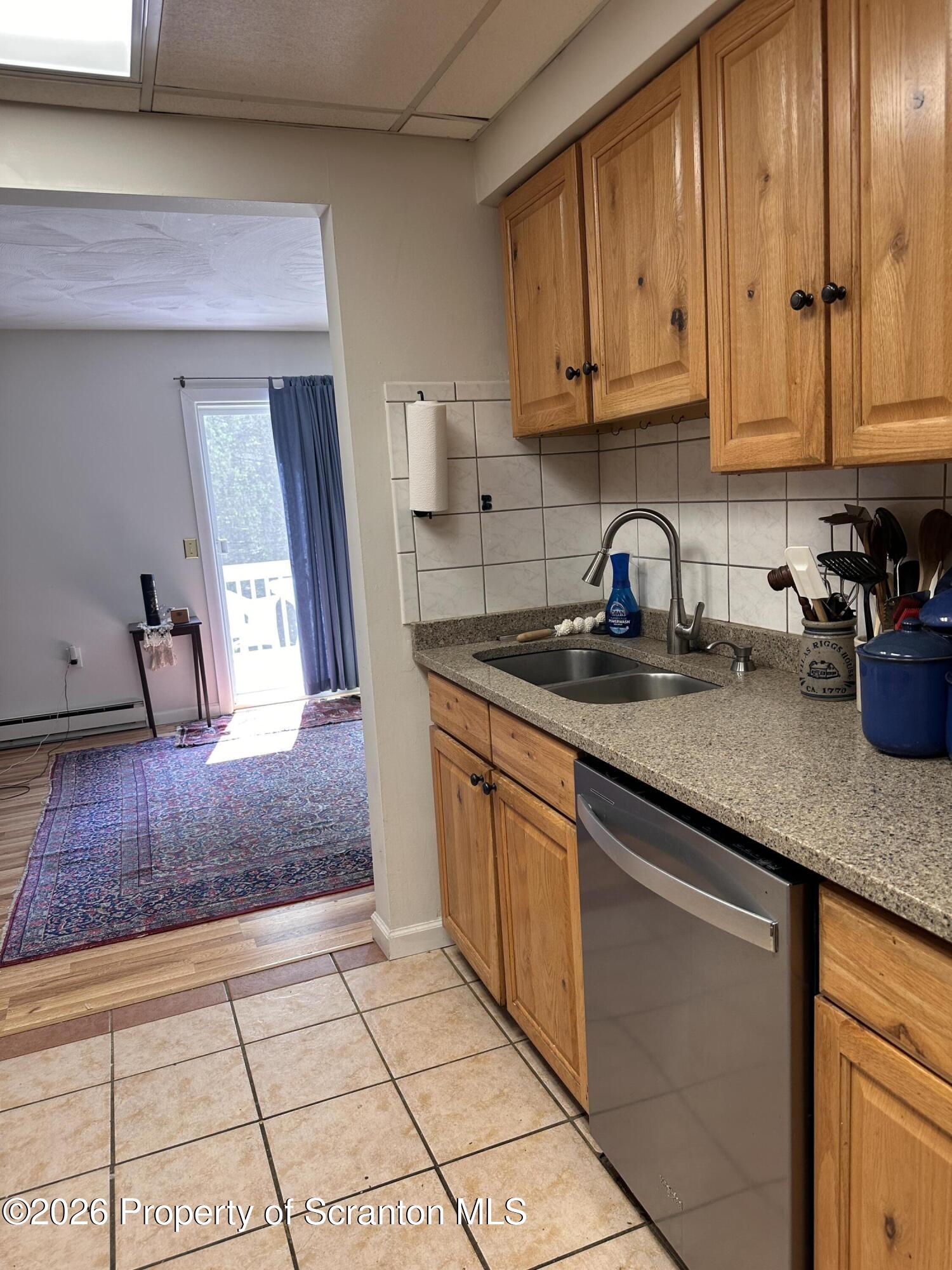 107 Keystone Hls Road, Unit 405 Factoryville, PA 18419 - Photo 12 of 27 a kitchen with stainless steel appliances granite countertop a sink a stove and cabinets