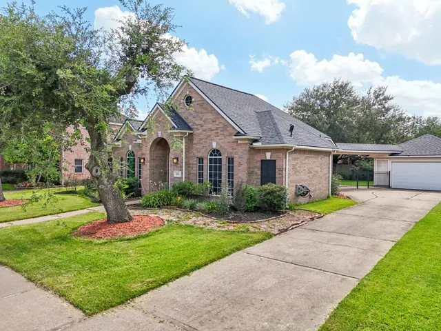 a front view of a house with a yard and porch