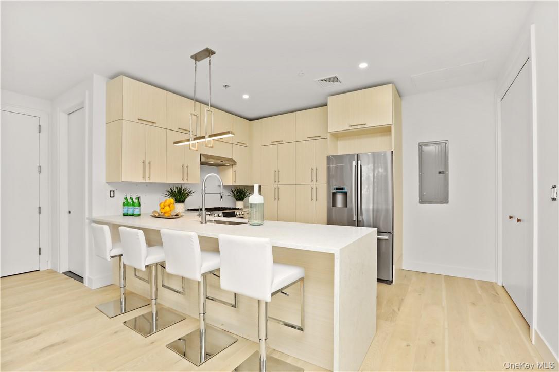 145 Library Lane, Unit 4A Mamaroneck, NY 10543 - Photo 10 of 27 Stunning open chefs kitchen boast 10’ long waterfall quartz countertop.