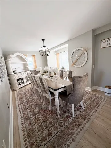 a dining room with furniture and wooden floor