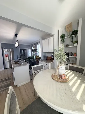a kitchen with a dining table and chairs