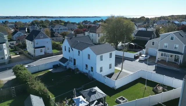 an aerial view of multiple houses with a yard