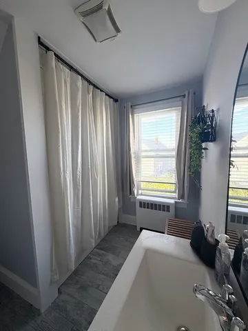 a room that has a bed and a window in it