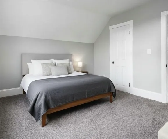 a bedroom with a bed and a night stand