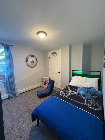 a bedroom with bed and a window