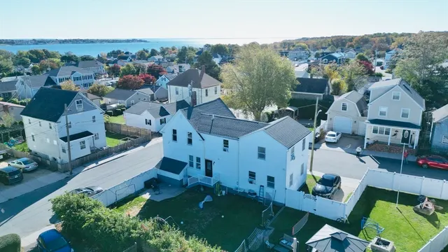 an aerial view of multiple houses with a yard