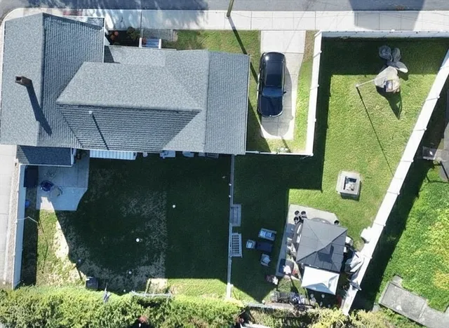 an aerial view of a house with a yard