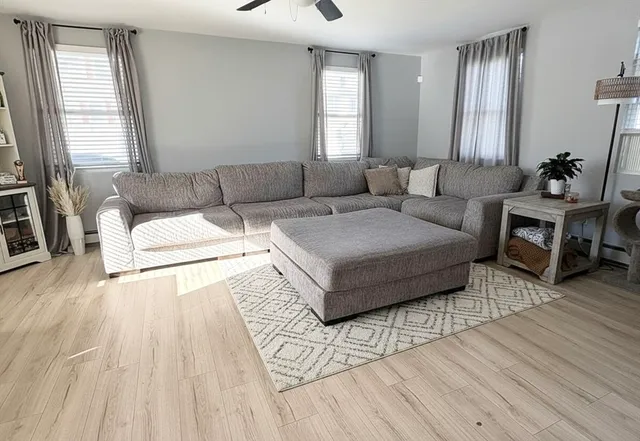 a living room with furniture and wooden floor