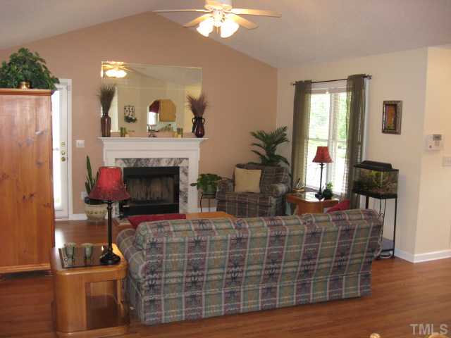 4000 Old Coach Road Raleigh, NC 27616 - Photo 5 of 12 a living room with furniture a fireplace and a chandelier