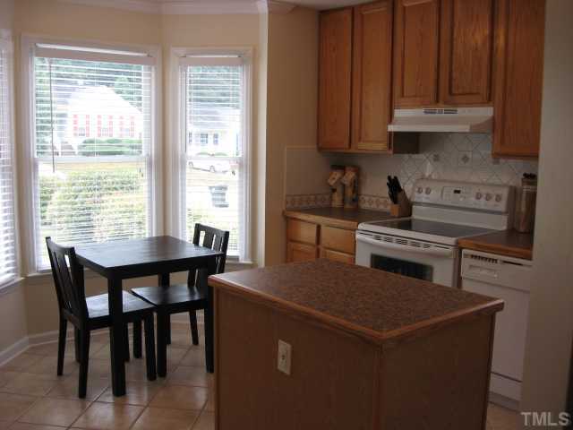 4000 Old Coach Road Raleigh, NC 27616 - Photo 7 of 12 a kitchen with a wooden table and chairs